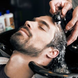 A male having his hair washed.